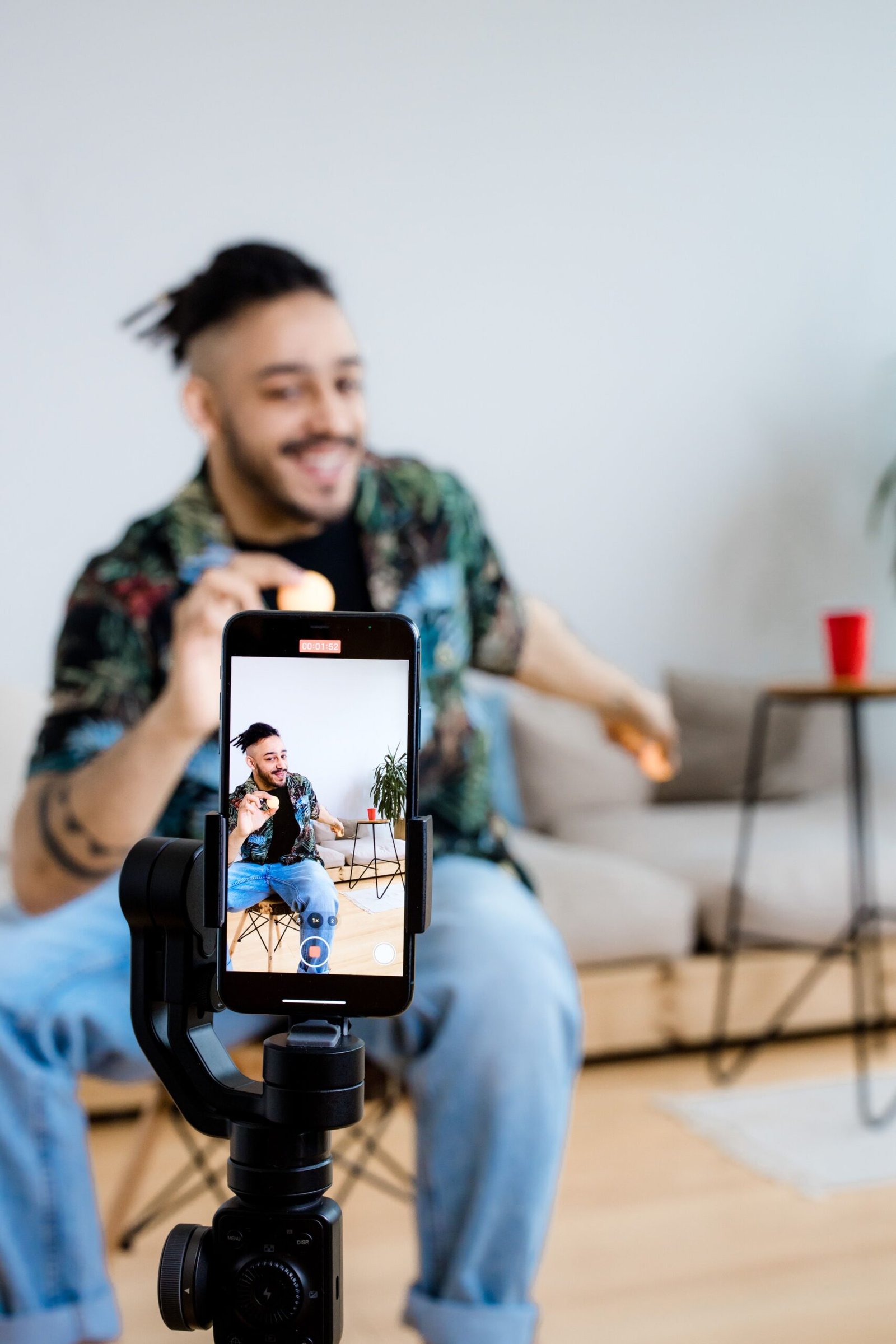 Person recording social media content on a phone with tripod